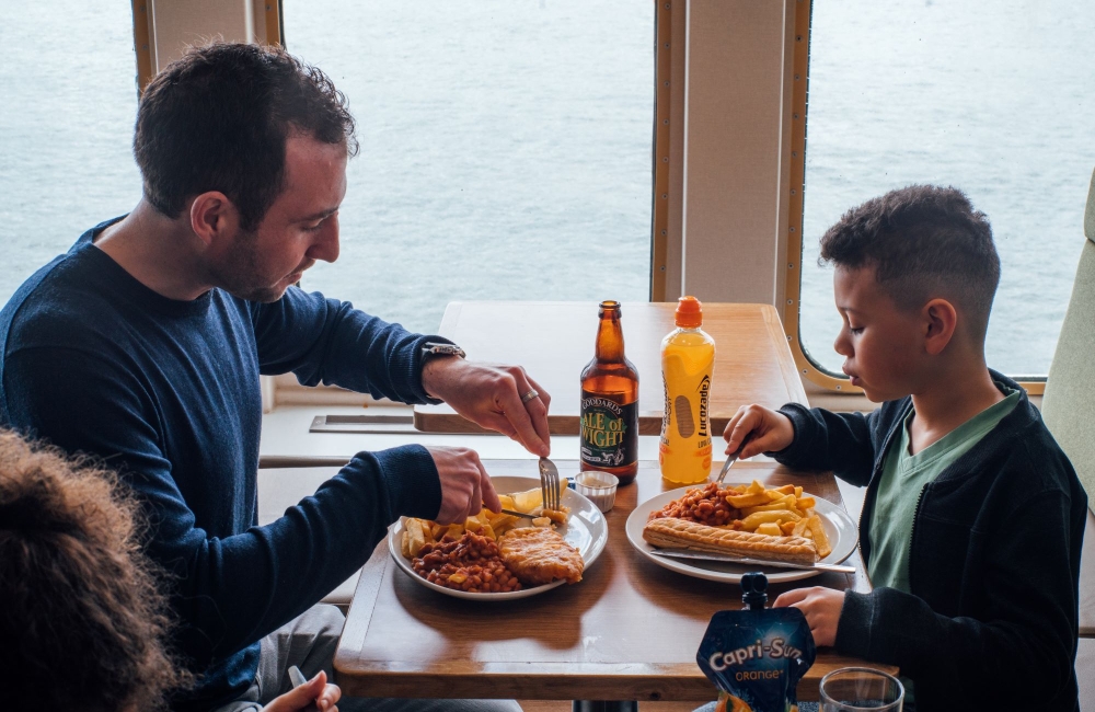 Father and son enjoying food on the ferry