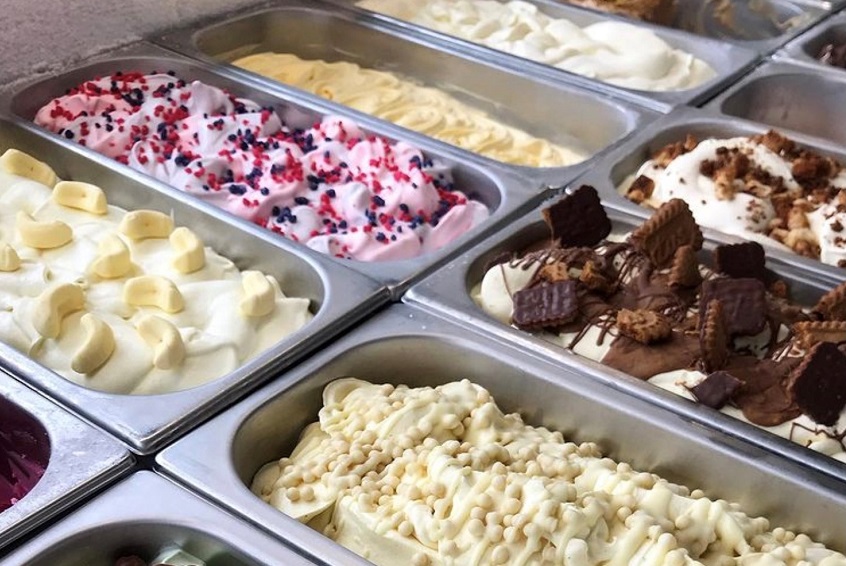 Rows of artisanal gelatos in metal containers