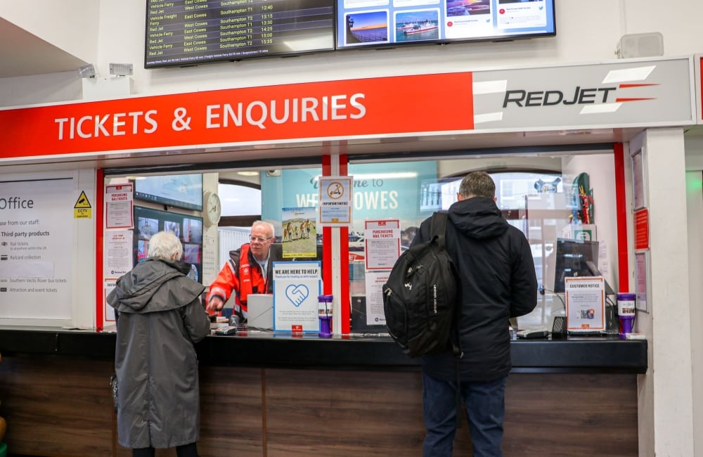 staff assisting at the red jet ticket office