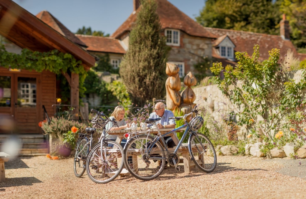 Couple sitting outside eating at the Garlic Farm