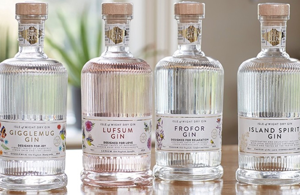 four bottles of gin lined up on a table