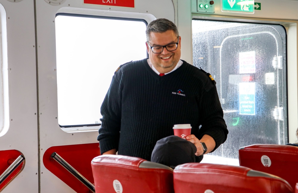 Cabin Attendant serving drinks to customers seat