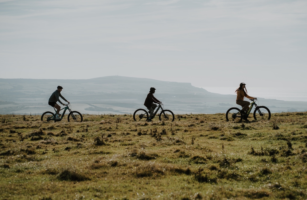 Group of friends mountain biking on a trail
