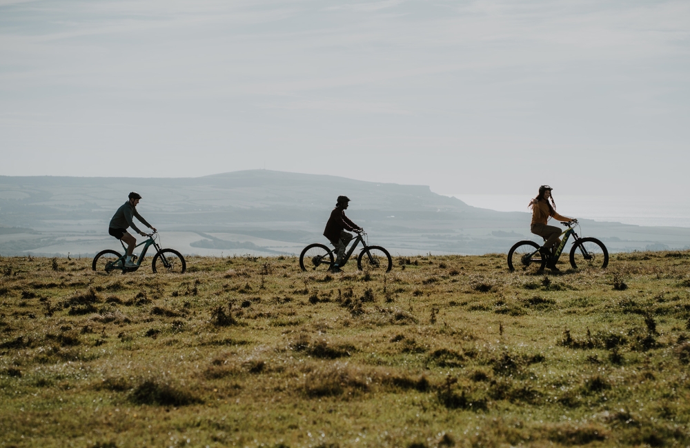 Group of friends mountain biking on a trail 