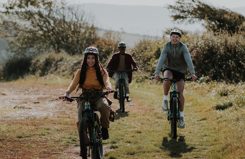 Group of friends mountain biking on a trail 