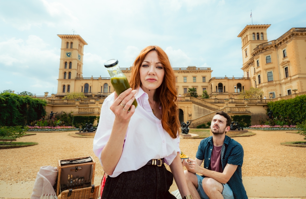 diane stood in front of osborne house with a bottle of green ketchup