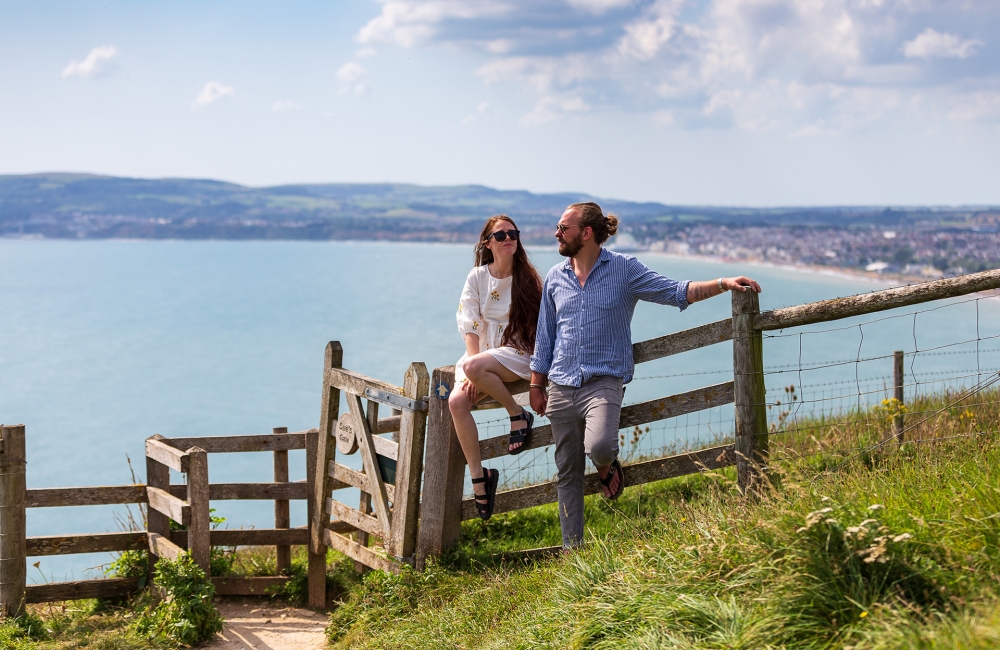 Two people hiking a coastal trail 