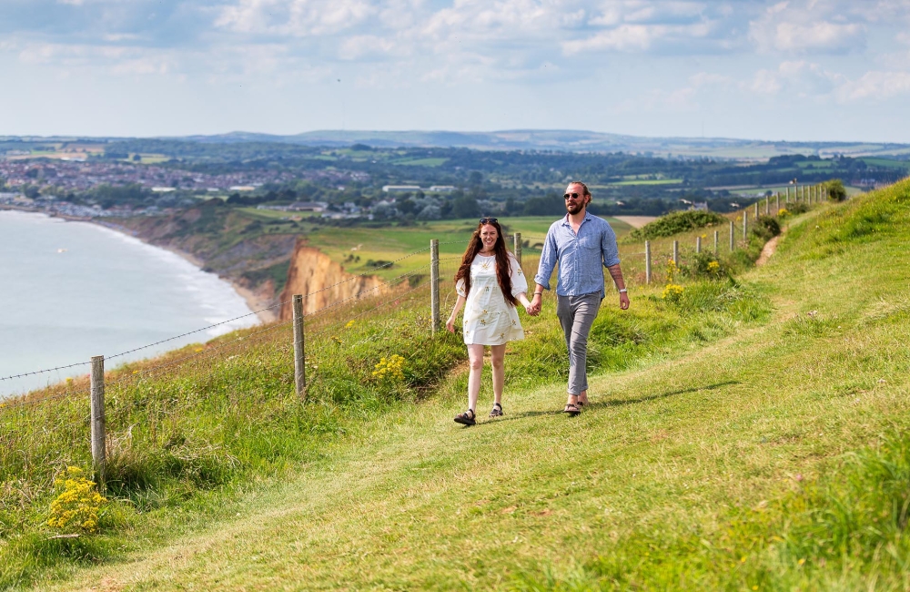 Two people hiking a coastal trail 