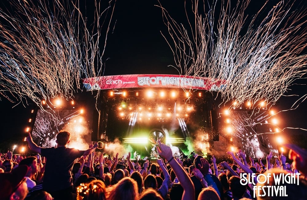 Festival stage lit up in the dark with confetti 