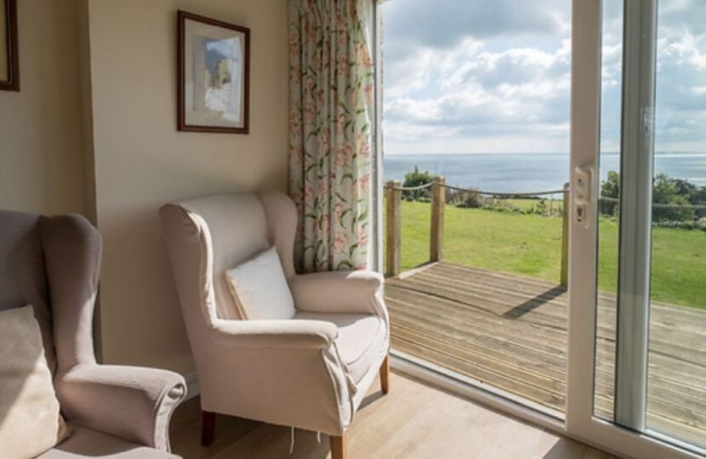 Bay View seating area in a bedroom with a sea view