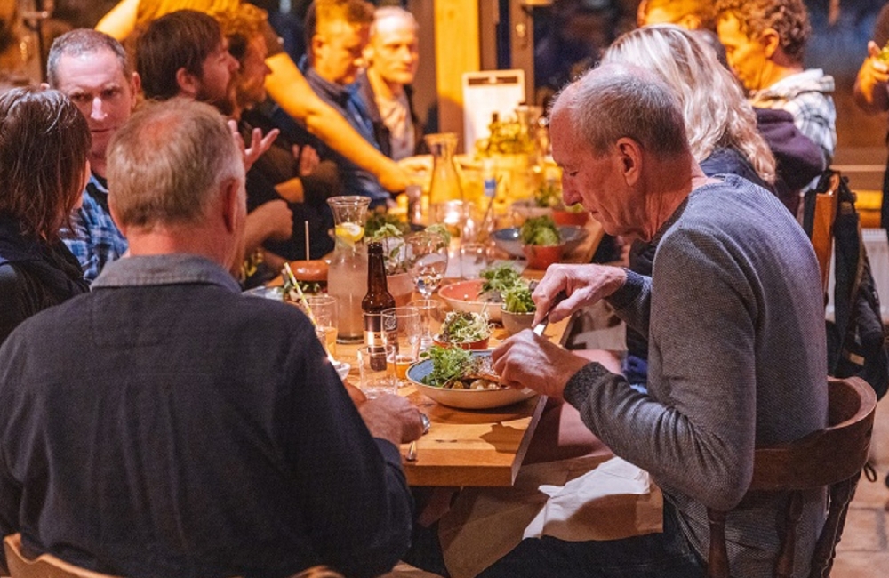 people sitting and eating at a table