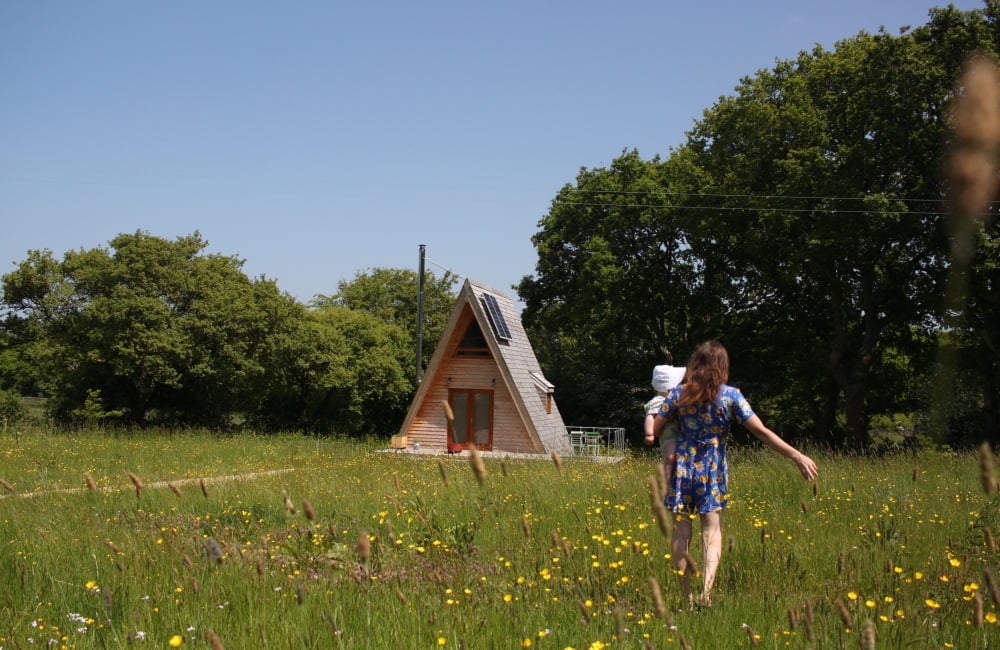 Tiny Homes Holidays a woman holding a child walking towards Silva