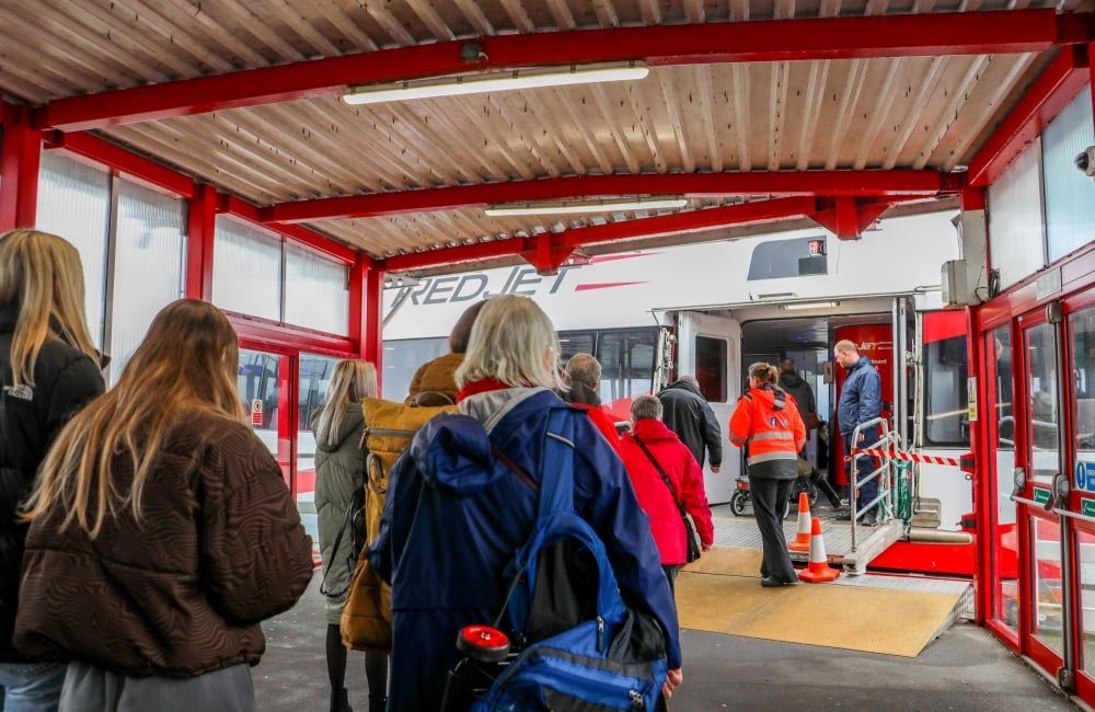 people boarding red jet in west cowes