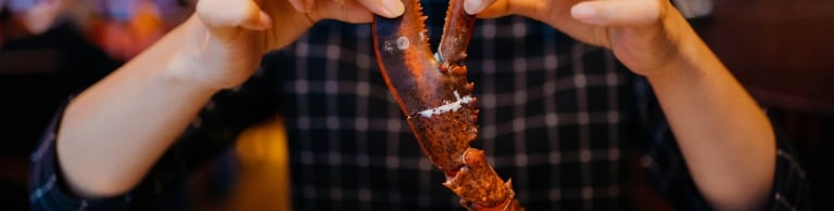 Woman holding a crab leg