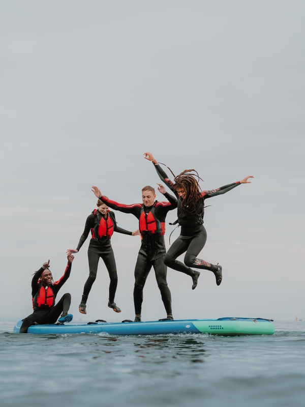 Group of friends on paddle boards in the ocean 