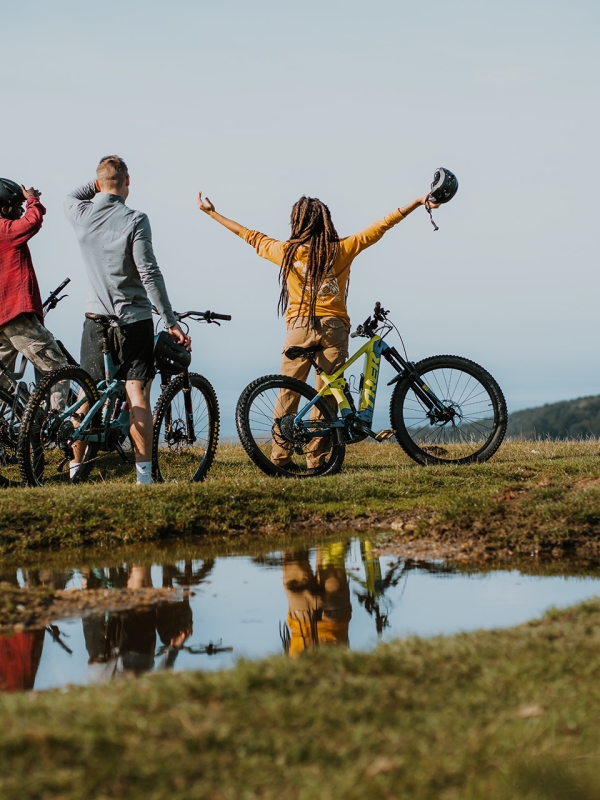 Group of friends mountain biking on a trail 