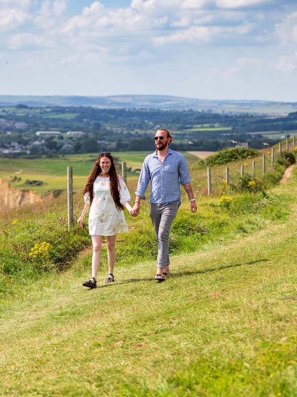 Two people hiking a coastal trail 