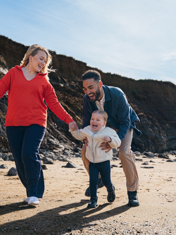 family playing on the beach
