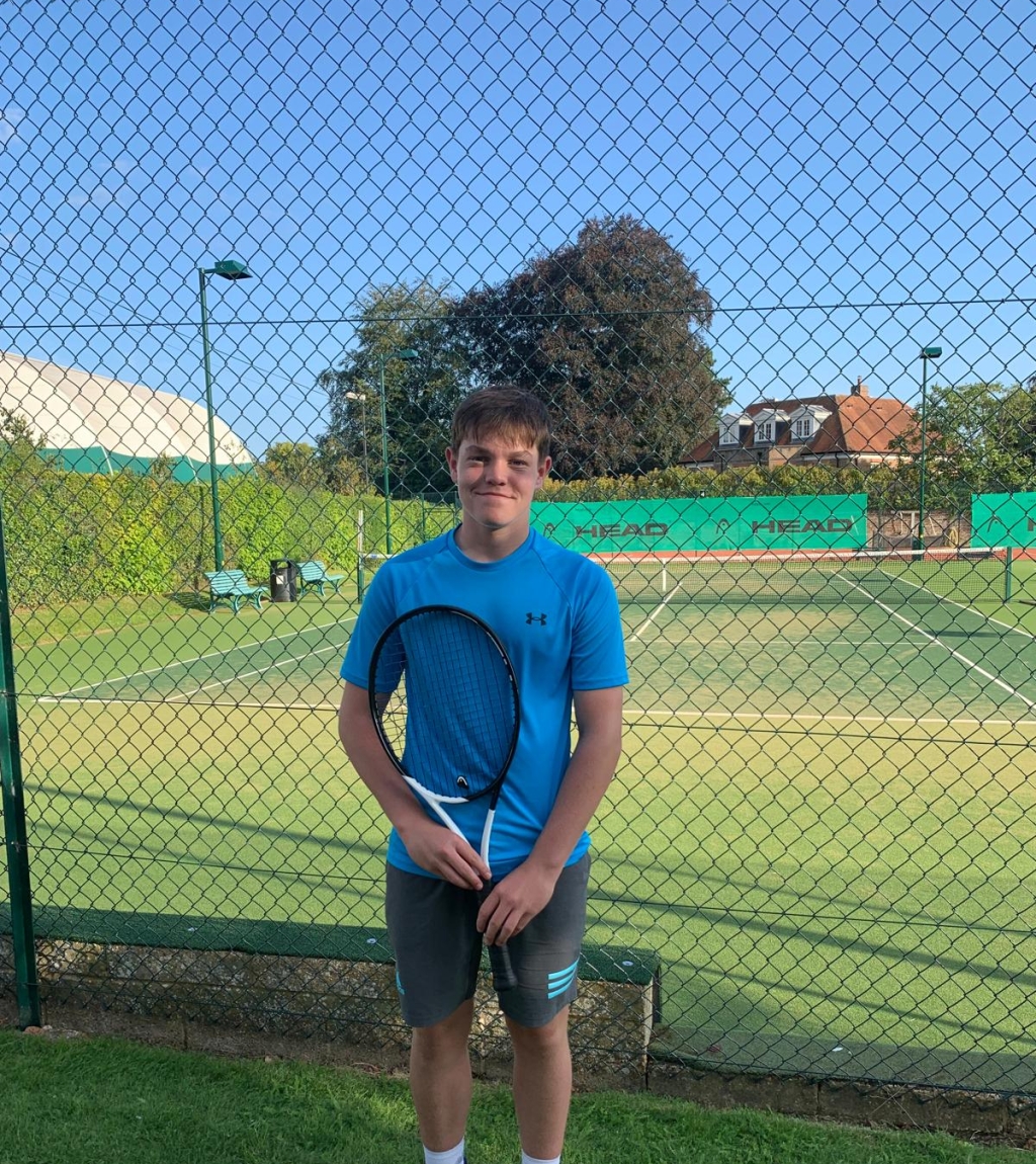 Toby Trotman in front of the tennis courts