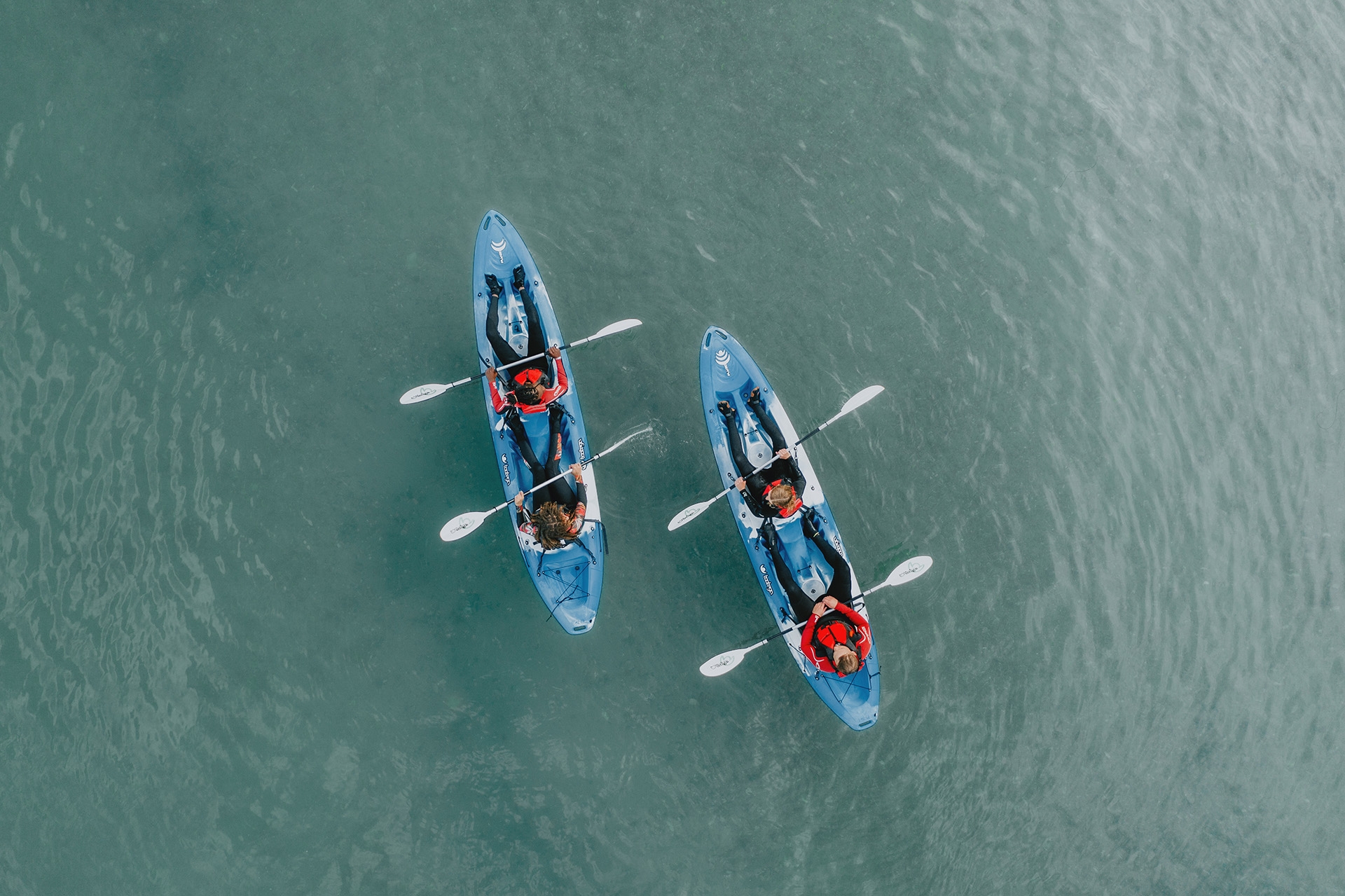 Group of friends on kayaks in the ocean 