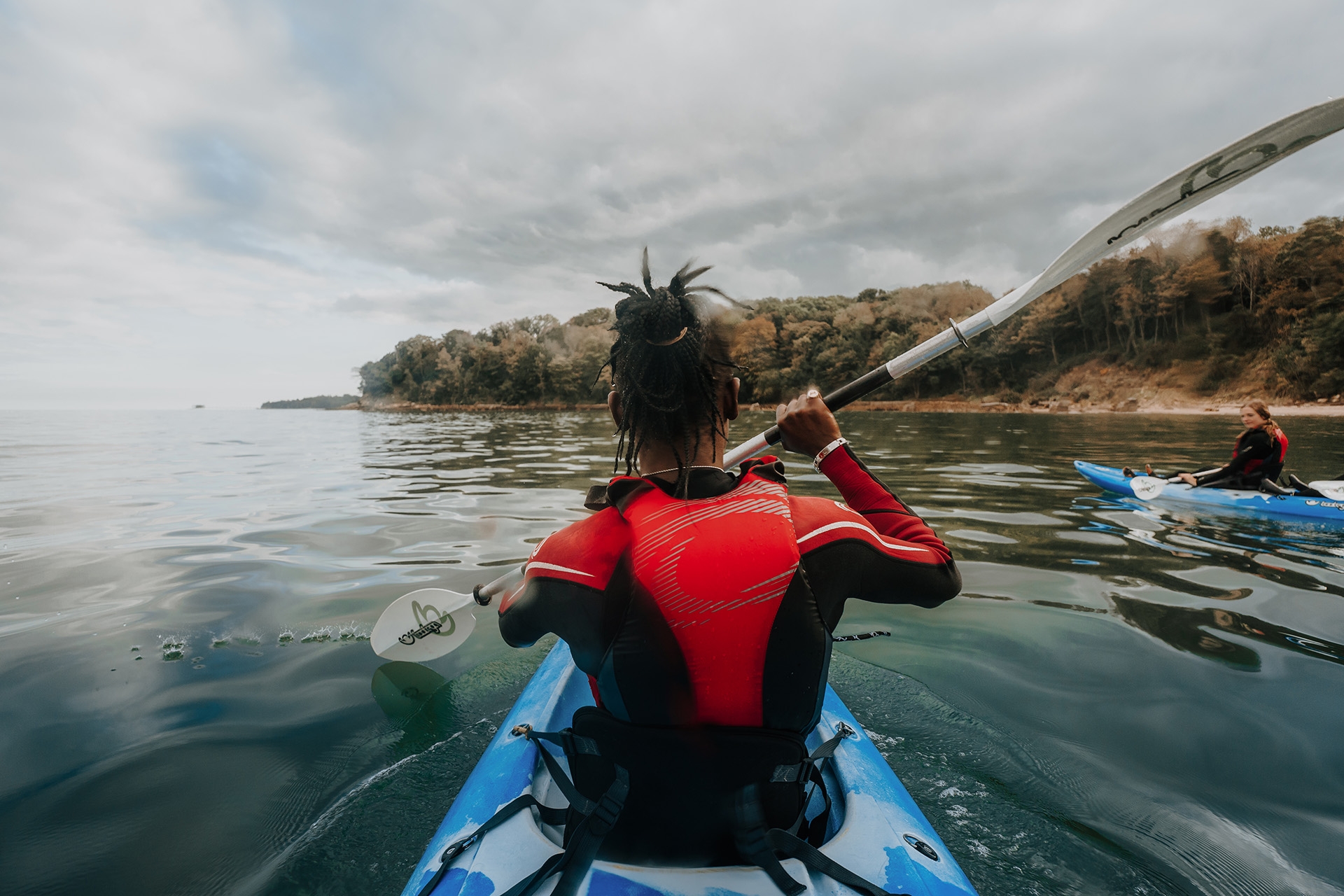 Group of friends on kayaks in the ocean 