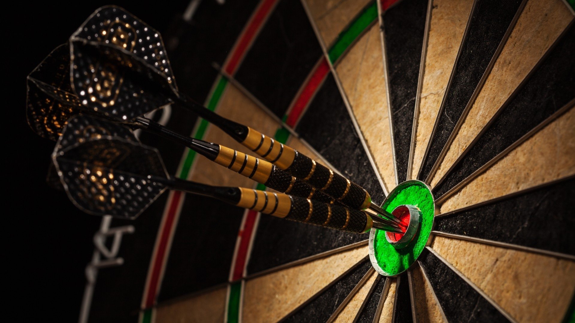 darts in the bullseye of a darts board