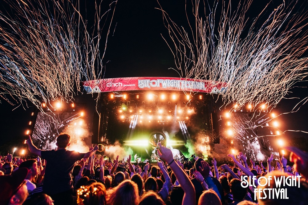 Festival stage lit up in the dark with confetti 