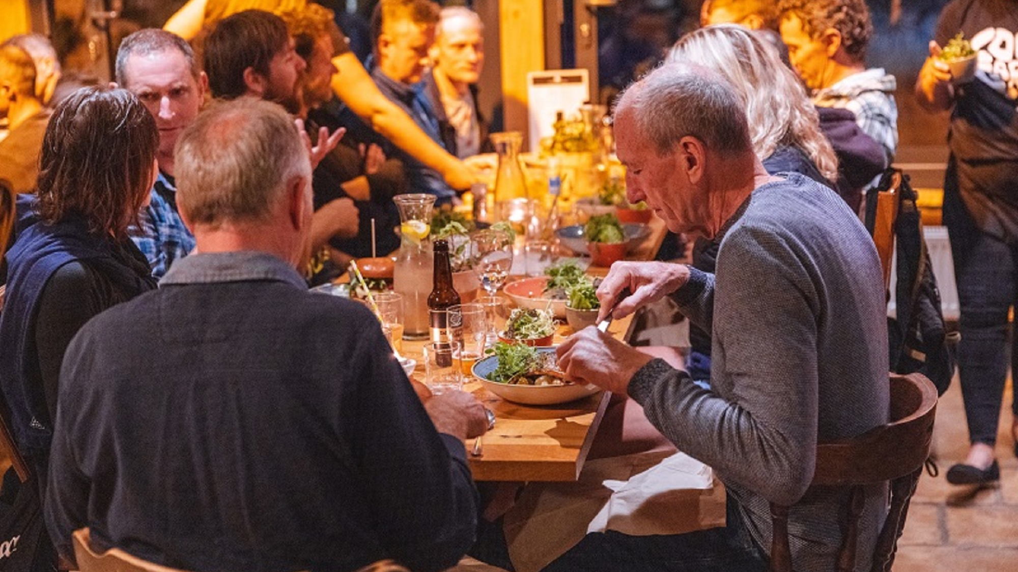 people sitting and eating at a table