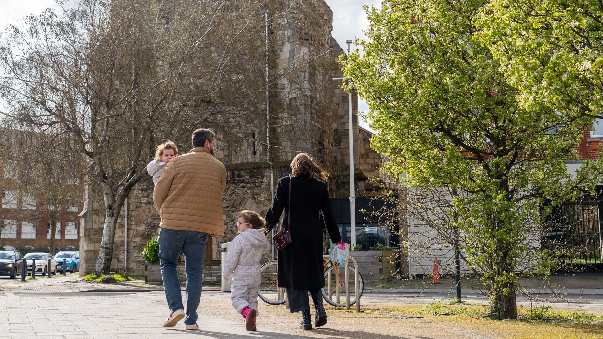 a family with two young children walking in southampton