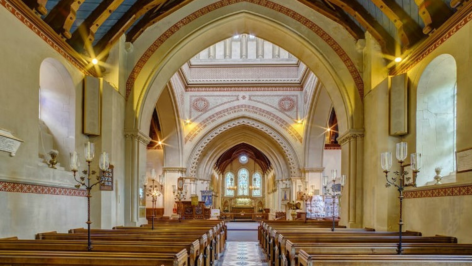 interior of st mildreds church, pews in the foreground and altar at the back