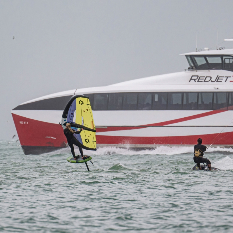 kite surfing in front of the red jet