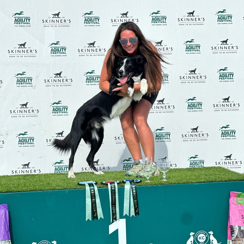 abs and dog dash pose atop the podium