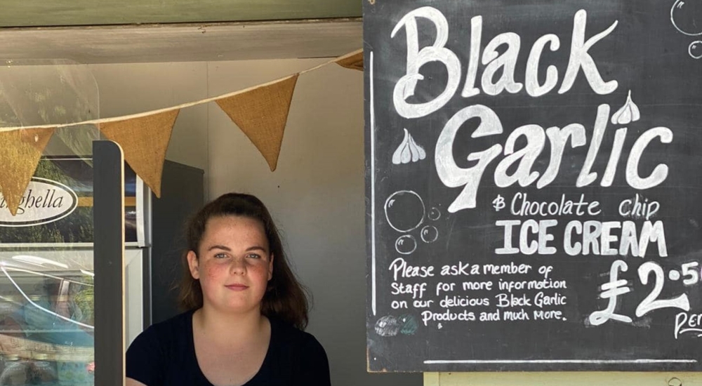 a sign advertising black garlic ice cream