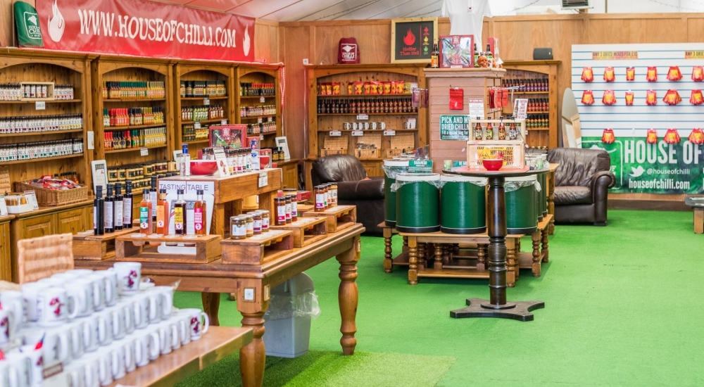 inside the shop with bottles of hot sauce on tables