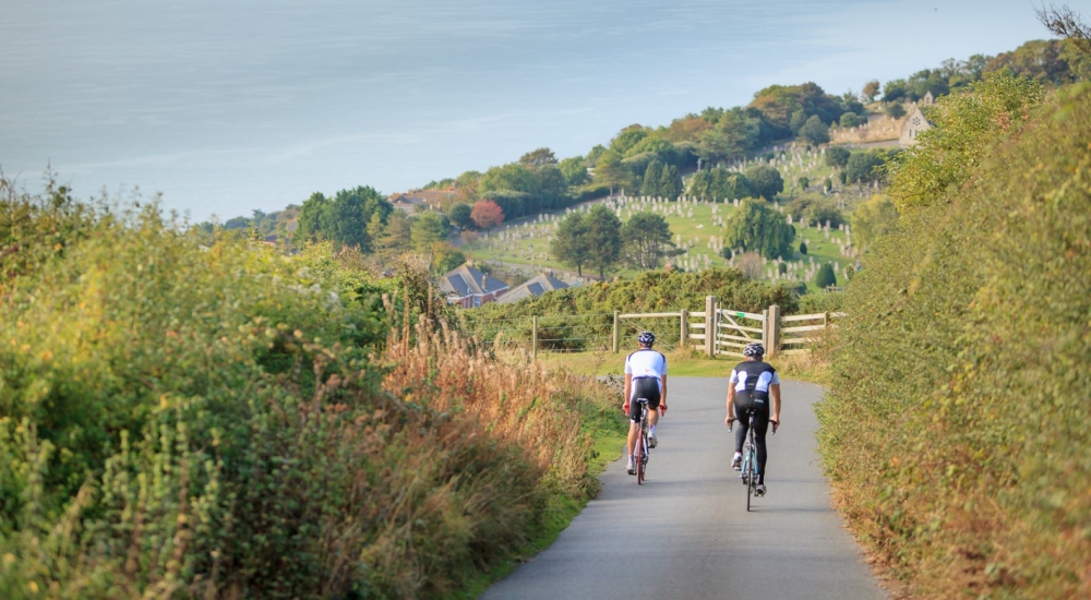two cyclists on a country lane