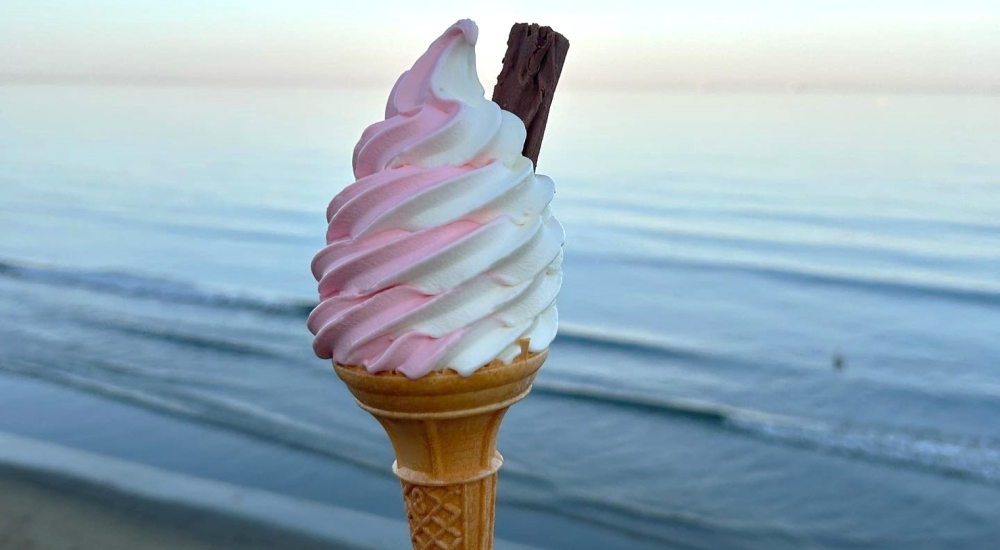 a pink and white whippy ice cream cone 