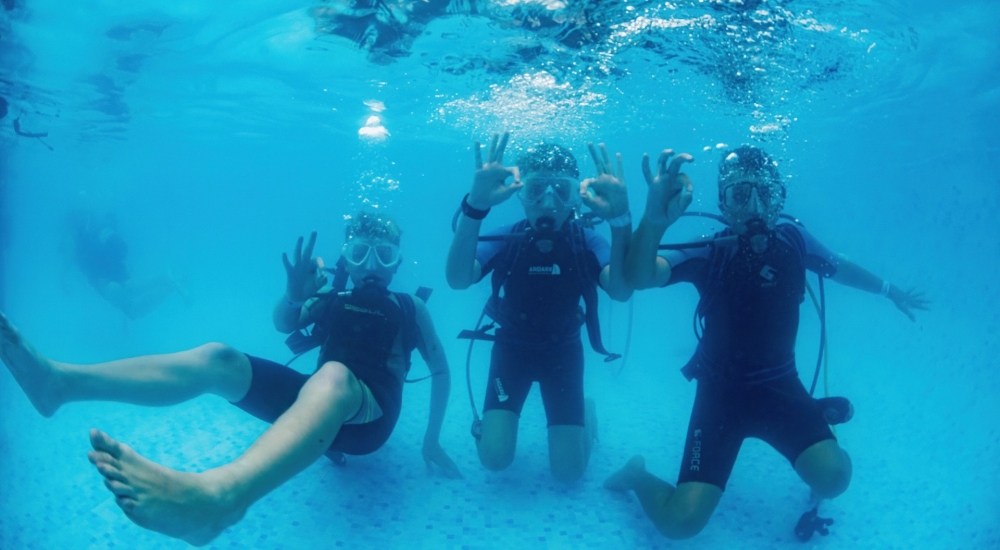 people scuba diving in a pool 