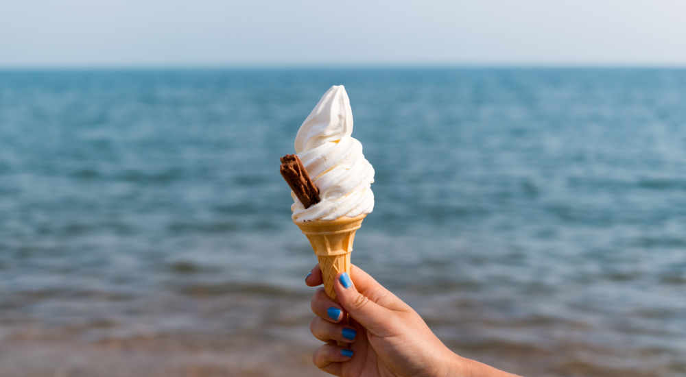 a hand holding an ice cream cone