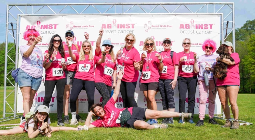 a group of women pose in matching pink t shirts
