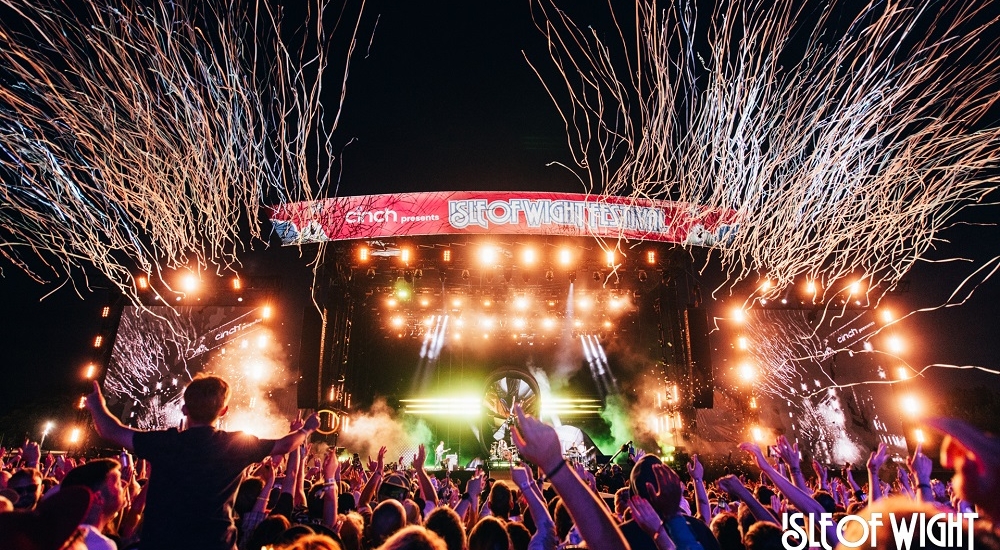 Festival stage lit up in the dark with confetti 