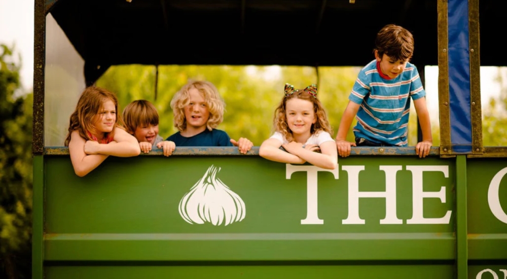 kids in a farm trailer