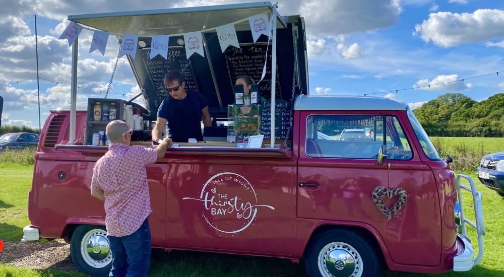 serving drinks from a converted VW Camper bar