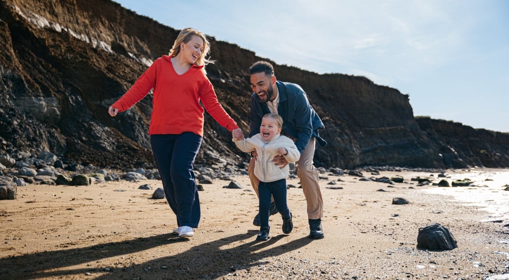 family playing on the beach