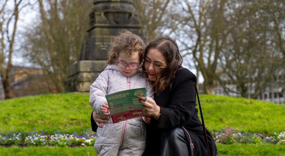 a young child looking at a trail map